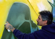 graffiti artist seen working on wall