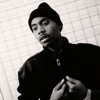 rapper nas standing in front of wire mesh
